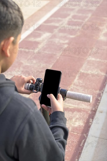 Young man riding an electric scooter outdoors