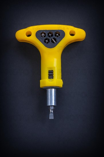 Yellow hand screwdriver Aerial view on black background