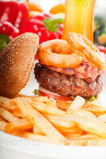 Classic american hamburger sandwich with onion rings and french fries