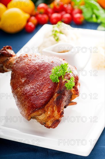 Original German BBQ pork knuckle served with mashed potatoes and sauerkraut