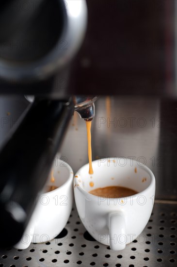 Italian espresso coffe making with professional machine macro