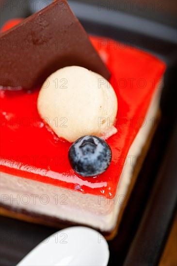 Fresh strawberry yogurt mousse with macaroon and blueberry on top