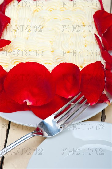 Whipped cream mango cake with red rose petals