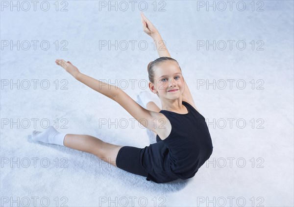 Image of a little girl in the gym. Gymnastics concept. Mixed media