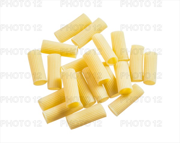 Heap of ribbed macaroni isolated on white