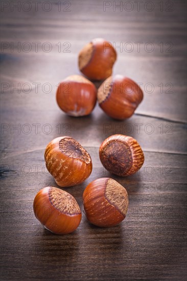 Seven hazelnuts on vintage wooden board Food and drink concept