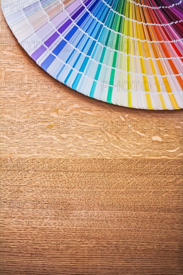 Multi-coloured Pantone fan on wooden board Construction concept