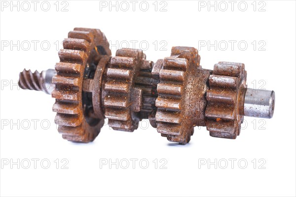 Old dusty and rusty block gearbox against a white background