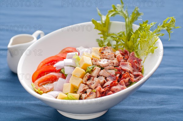 Fresh classic caesar salad over blue tablecloth close up