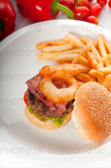 Classic american hamburger sandwich with onion rings and french fries