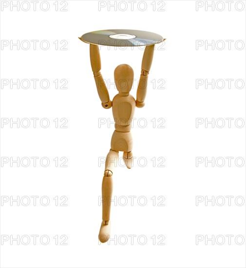 Wood mannequin with CD-rom on white background