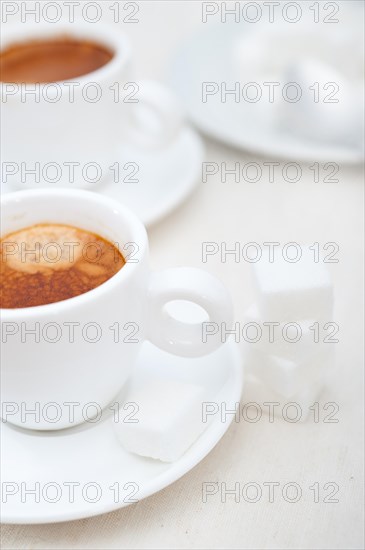 Italian espresso coffee fresh brewed macro closeup with sugar cubes