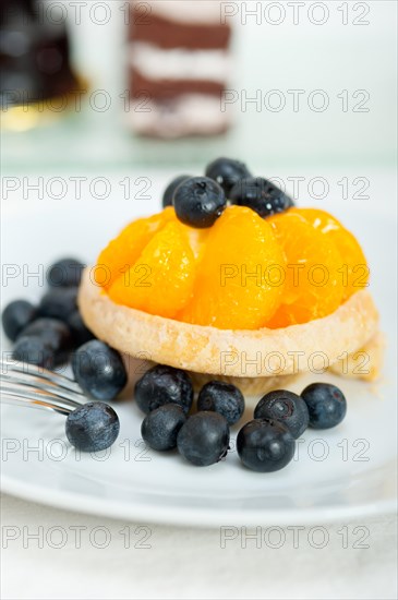 Fresh blueberry and tangerine orange cream cupcake homemade closeup macro