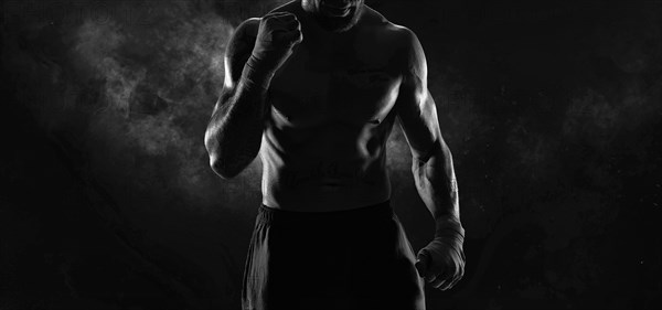 Noname image of a kickboxer on a dark background. The concept of mixed martial arts. MMA