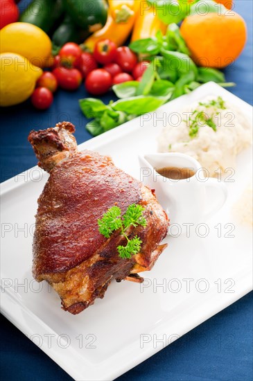 Original German BBQ pork knuckle served with mashed potatoes and sauerkraut