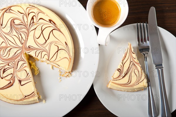 Fresh baked classic Cheese cake with chocolate topping and espresso coffee