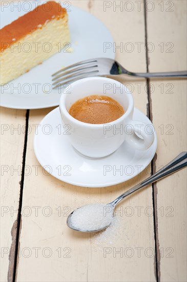 Italian espresso coffee and cheese cake over white wood table