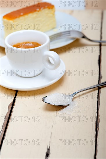 Italian espresso coffee and cheese cake over white wood table