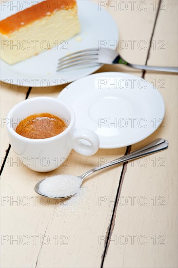 Italian espresso coffee and cheese cake over white wood table