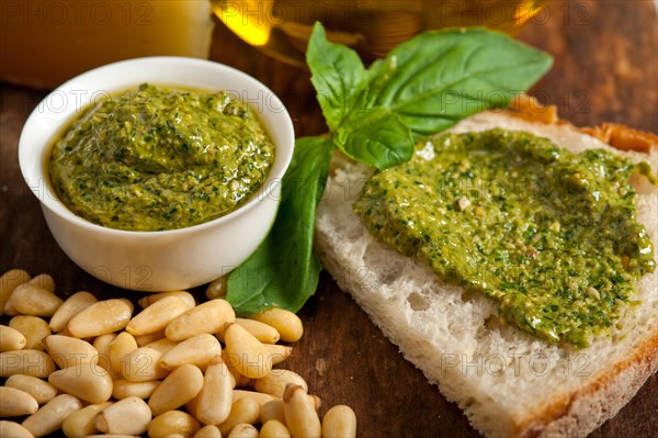 Italian basil pesto bruschetta ingredients over old wood macro