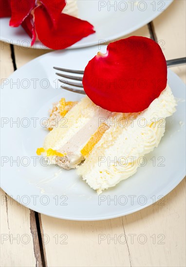 Whipped cream mango cake with red rose petals