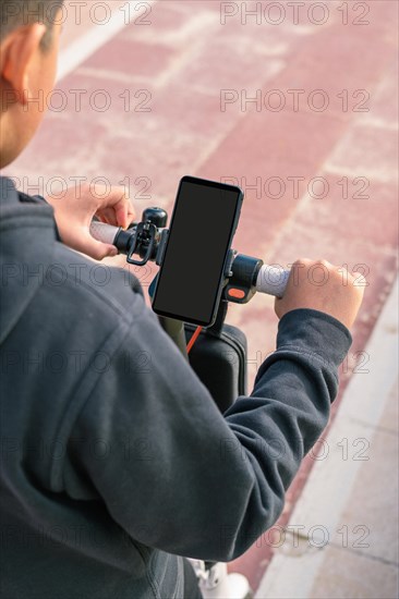 Young man riding an electric scooter outdoors