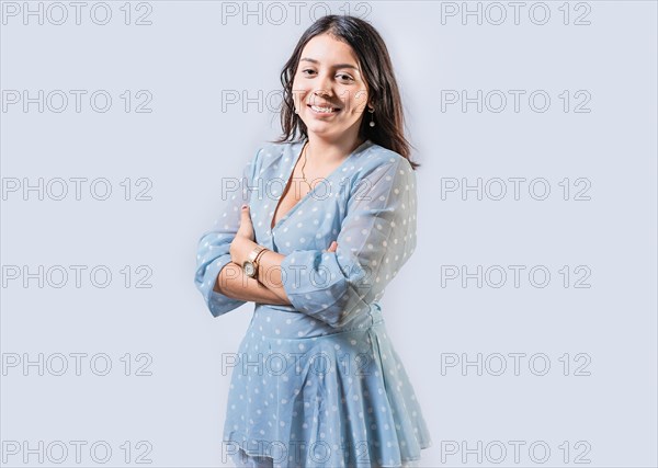 Portrait of smiling girl with arms crossed isolated. Cheerful young woman with arms crossed isolated