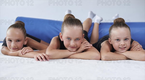 Image of a group of little girls in the gym after a workout. Gymnastics concept. Mixed media