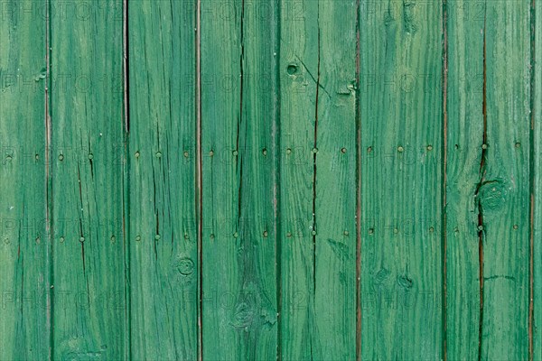 Old wooden door with aged metal door handle. Architectural textured background