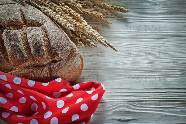 Brown bread rye ears red polka-dot fabric on white board