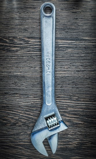 Adjustable spanner on wooden board