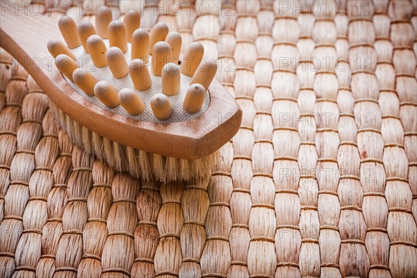 Horizontal image of wooden massager with scrubber on willow background healthcare concept