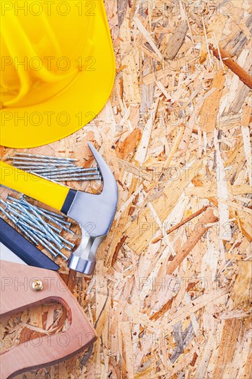 Copyspace image set of construction tools helmet claw hammer nails and handsaw on plywood