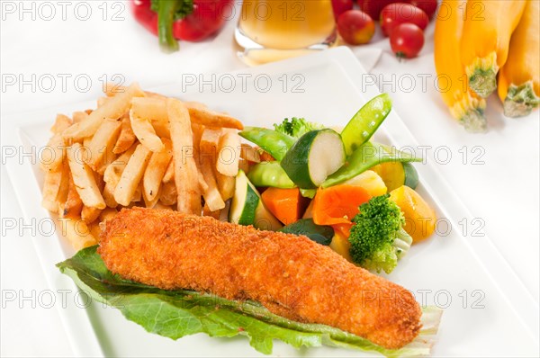 Fresh breaded chicken breast roll and vegetables