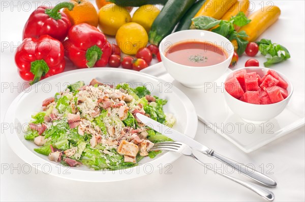 Fresh classic caesar salad served with gazpacho soup