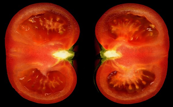 Ripe tomato cutted in half on black background
