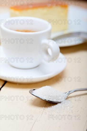 Italian espresso coffee and cheese cake over white wood table