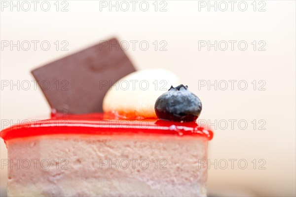 Fresh strawberry yogurt mousse with macaroon and blueberry on top