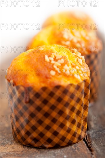 Fresh baked muffin on old wood table