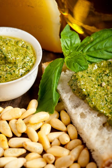 Italian basil pesto bruschetta ingredients over old wood macro