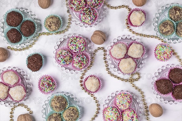 Light and dark rum balls on and next to glass plates