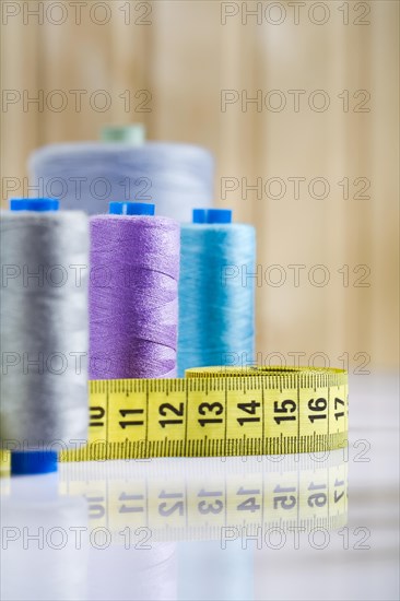 Bobbins and measure tape on table