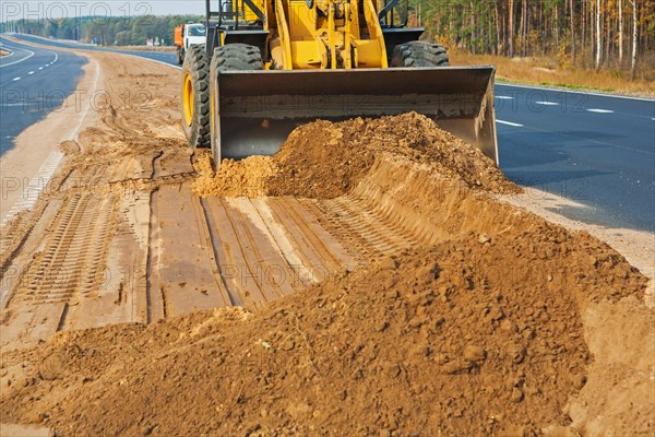 Wheel loader at work with sand