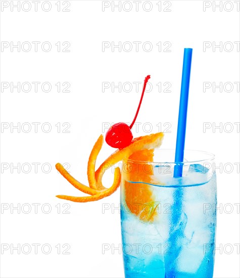 Blue long drink cocktail with orange and cherry garnish and blue straw