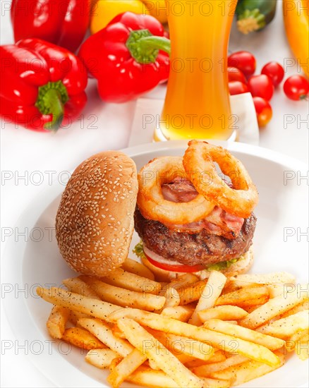 Classic american hamburger sandwich with onion rings and french fries