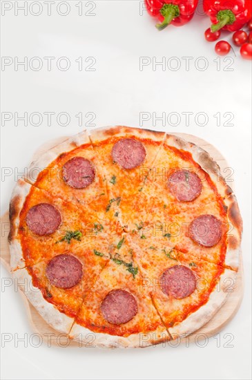 Italian original thin crust pepperoni pizza isolated on white