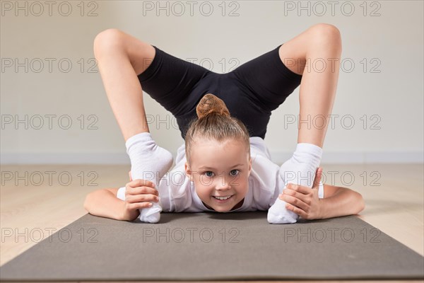 Little girl performs exercises in a gymnastics sports class. The concept of sports