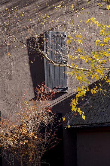 Stone facade and windows with wooden shutters in a rustic mountain setting in Catalonia in Spain