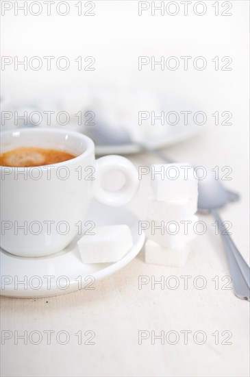 Italian espresso coffee fresh brewed macro closeup with sugar cubes