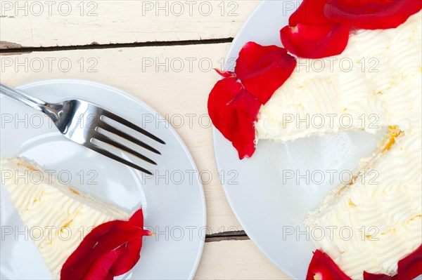 Whipped cream mango cake with red rose petals